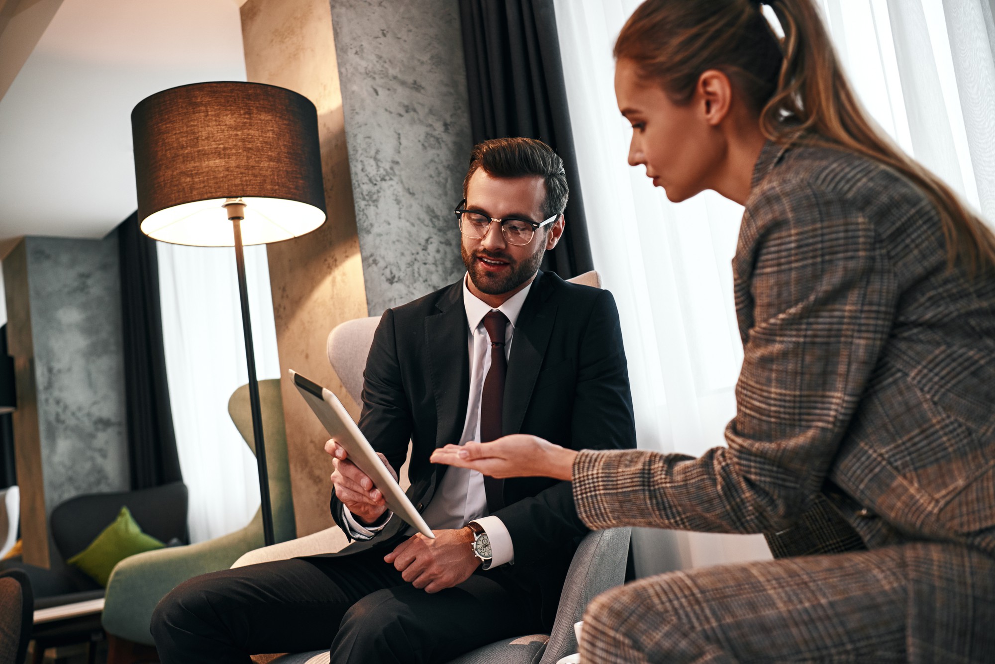 Advisor speaking with client in luxurious office